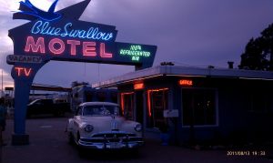 Blue Swallow Motel neon sign and classic car.