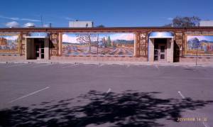 Murals on outside school walls depict early Santa Fe history.
