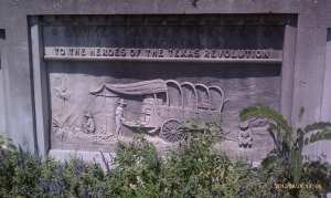 A chuck wagon scene carved in stone.