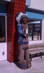 A colorful and tall wood carving.