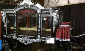 An elaborate horse drawn hearse.