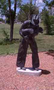 A cowboy rounds up a small calf.