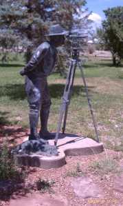 A surveyor lines up the position.