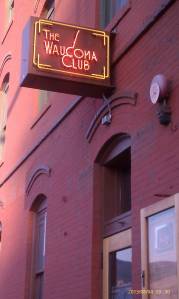 Cool neon sign against brick architecture.