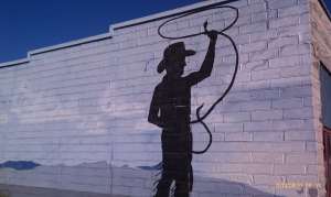 Pecos Bill swinging a rattlesnake lasso.