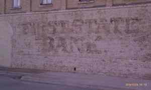 A bank ad on the wall is almost gone,