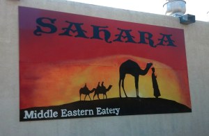 The reds, oranges, and yellows of a Sahara landscape.