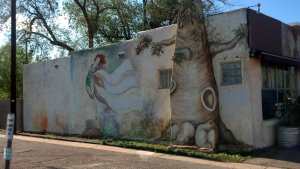 The mural blends in with the foliage behind.