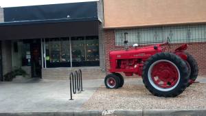 The one with the red tractor parked out front.