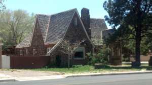 Stone house with high peaked roof.