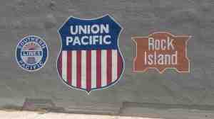 A mural of railroad logos.