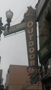 Vintage neon sign shows a cowboy riding a bronco.