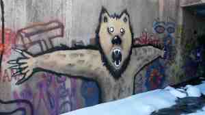 A bear prepares to battle a fox.