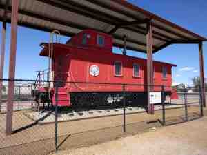 A classic red caboose on display.