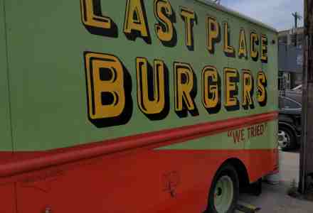 Side of food truck shows name: Last Place Burgers. Slogan: we tried.