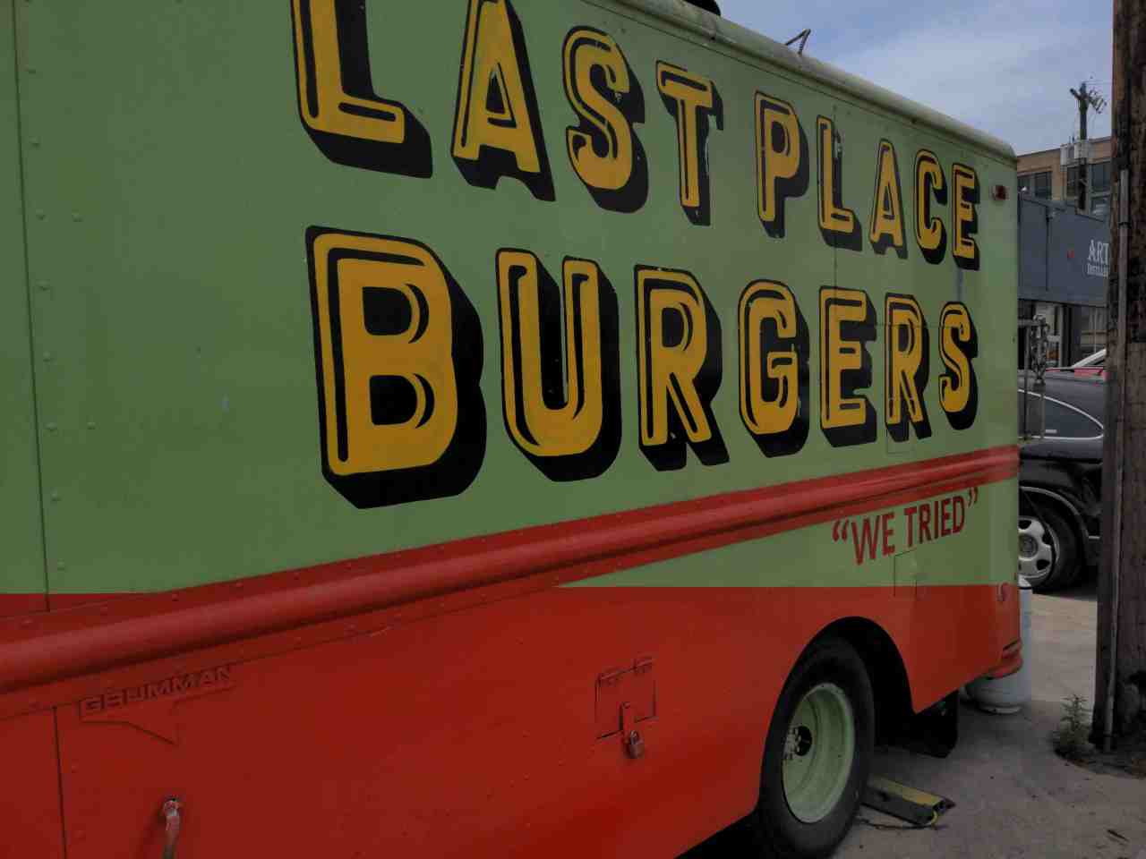 Side of food truck shows name: Last Place Burgers. Slogan: we tried.