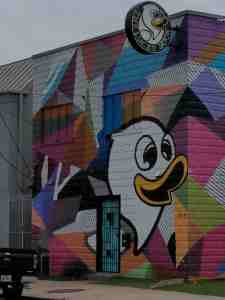 Color blocked mural on wall and sign for the Lucky Duck.