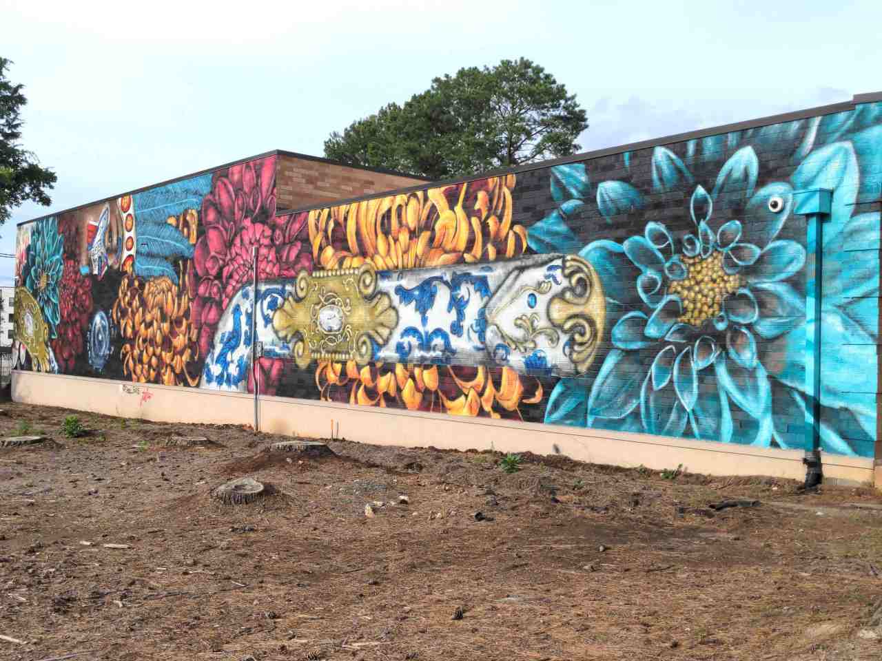 Mural along wall painted with vibrant colors and patterns.