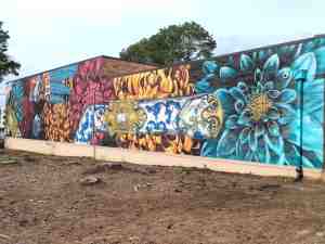 Mural along wall painted with vibrant colors and patterns.