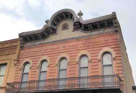Exterior and upper part of old building with architectural flourishes.