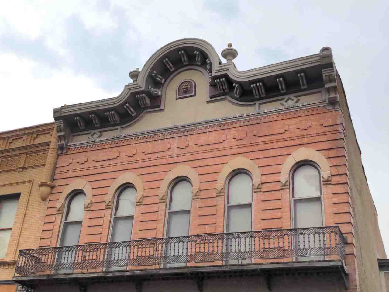 Exterior and upper part of old building with architectural flourishes.