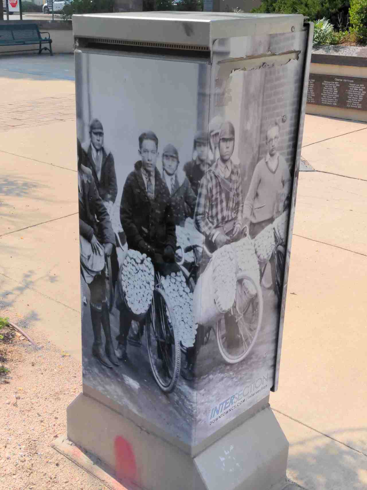 Utility box with mini mural of paper boys.