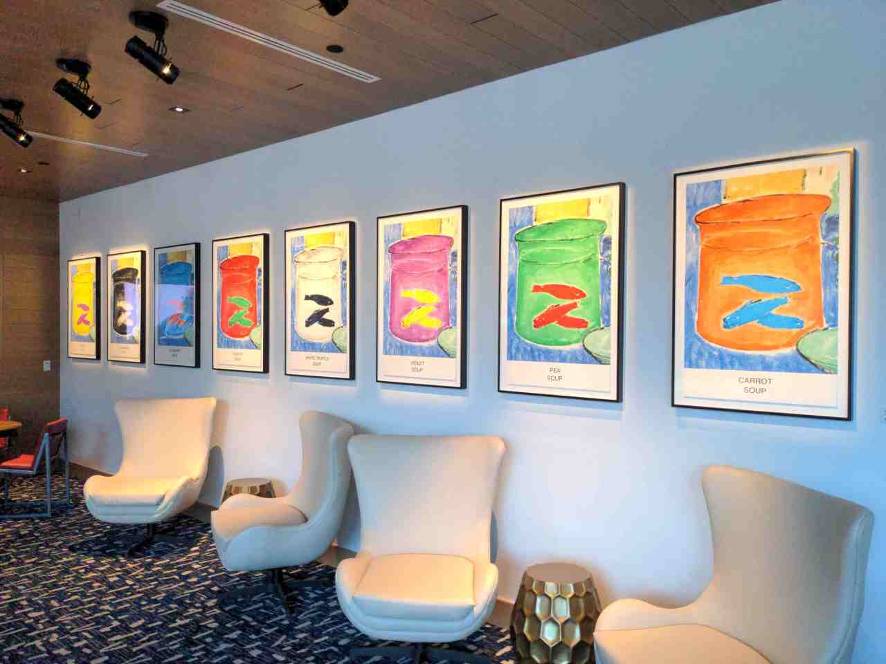 Hotel lobby area with art deco furnishings and original art on the walls.