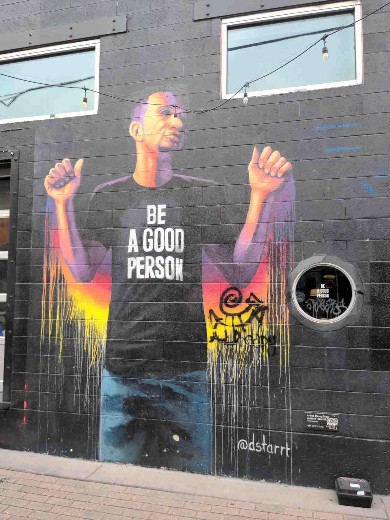 Mural of a man wearing a t-shirt that says "Be A Good Person."