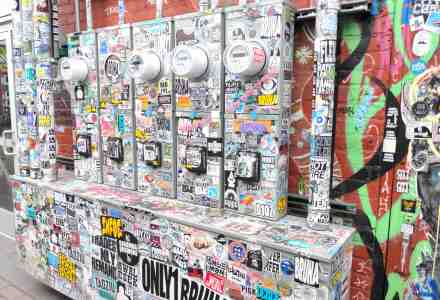 Utility meter boxes covered over with stickers.