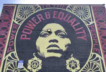 Mural of graphic design and portrait with words: "Power & Equality."
