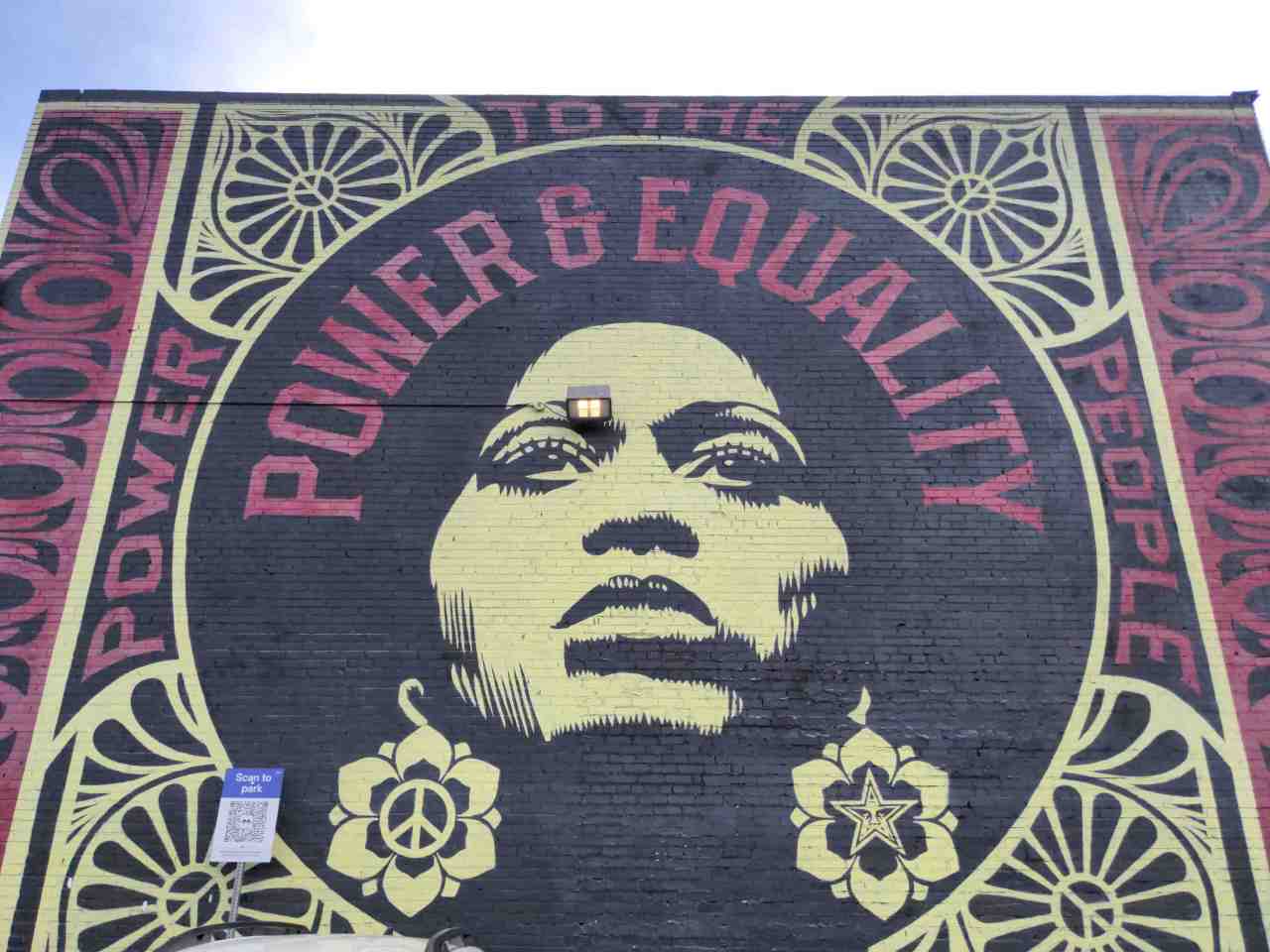 Mural of graphic design and portrait with words: "Power & Equality."