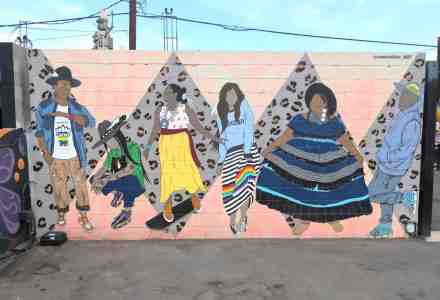 Mural of people gathering and dancing.