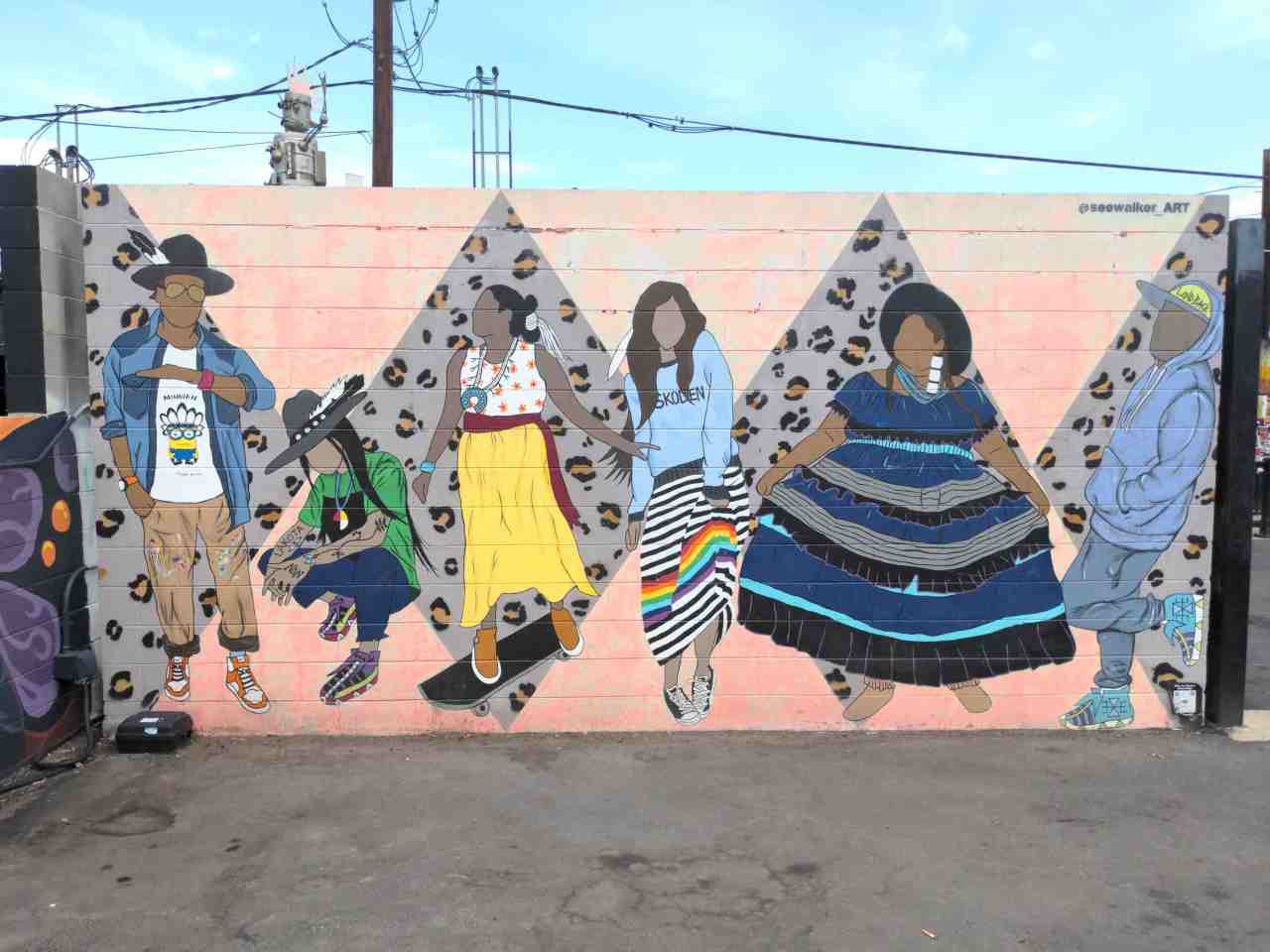 Mural of people gathering and dancing.